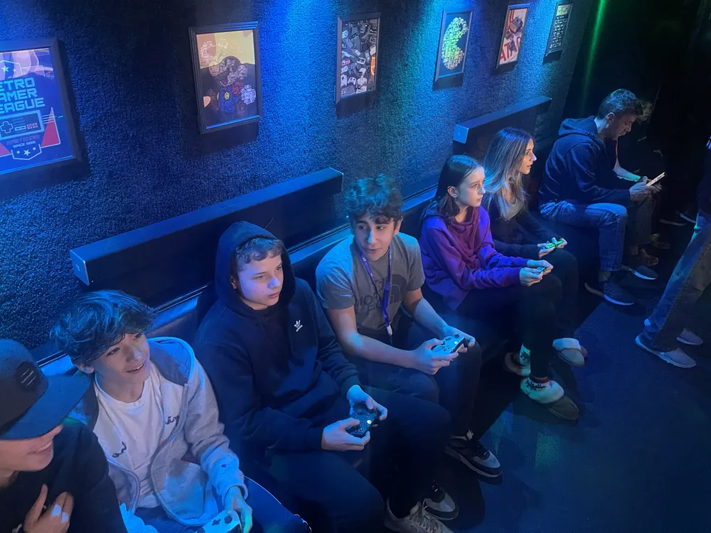 Teens and friends playing together on the benches inside the game truck