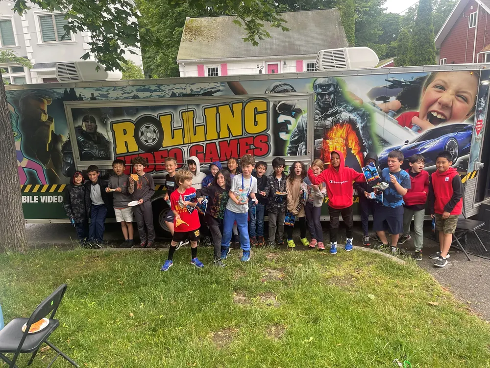 A class lined up in front of the Rolling Video Games truck at a school event