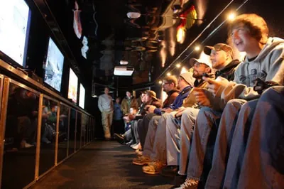 A row of screens and players inside the game truck