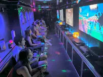 Stadium-style seating with kids gaming on multiple screens