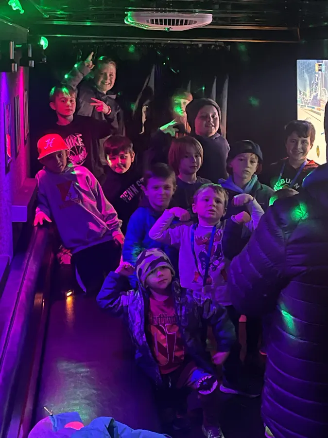 A full crowd of kids huddled together inside the game truck