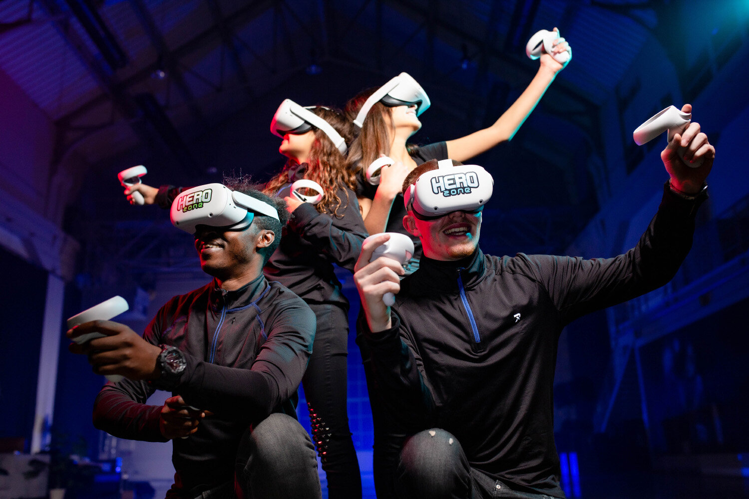 Four people playing together in Hero Zone VR headsets
